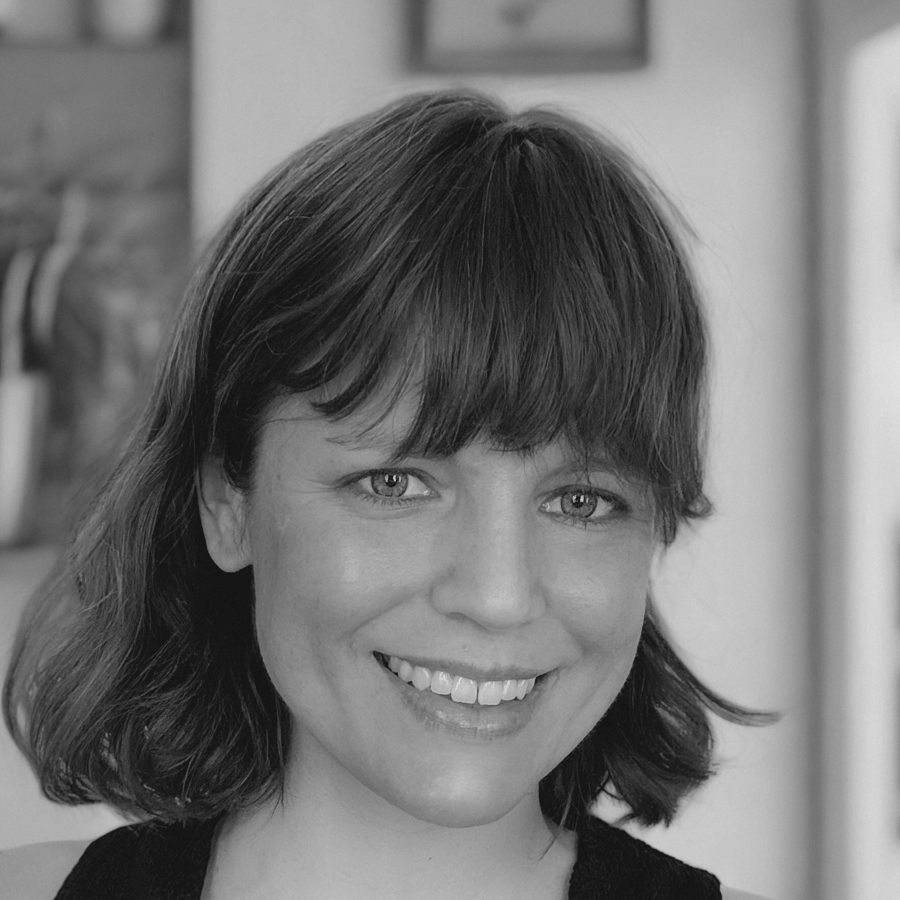 Jane Riccobono, smiling, in black and white